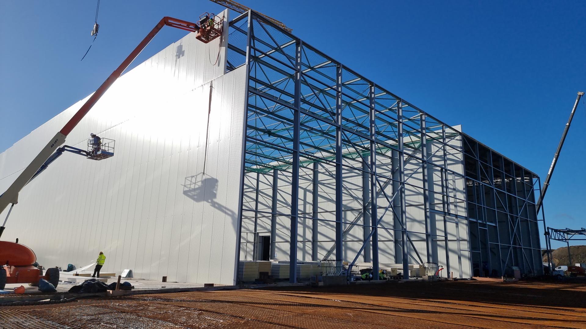 Cladding going up over the steel frame of a cold store under construction