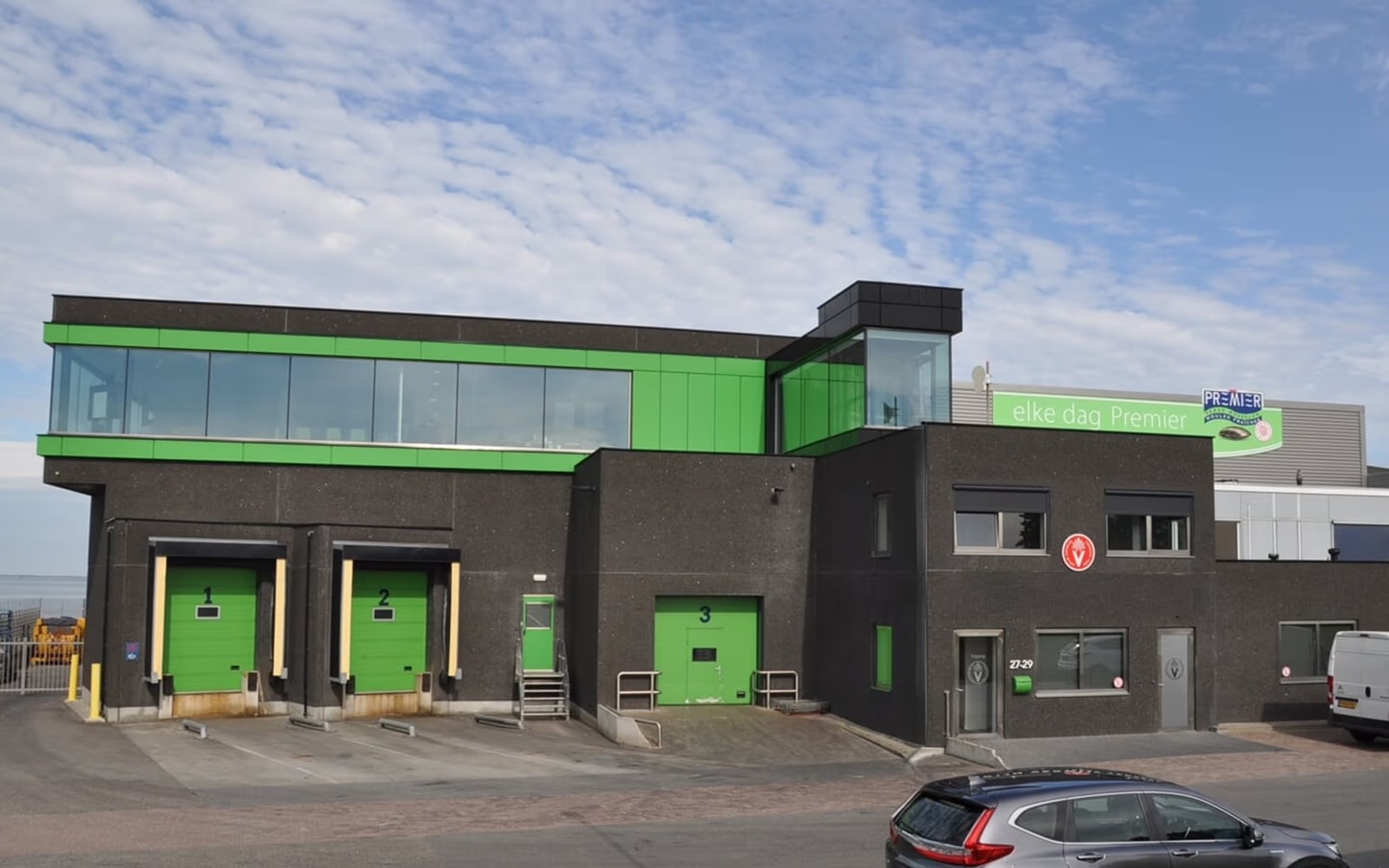 Processing and cold storage building with three loading bays and a first-floor office band